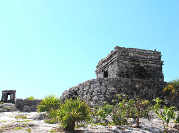 Low angle view of old ruins against clear blue sky