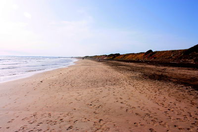 Scenic view of beach against clear sky