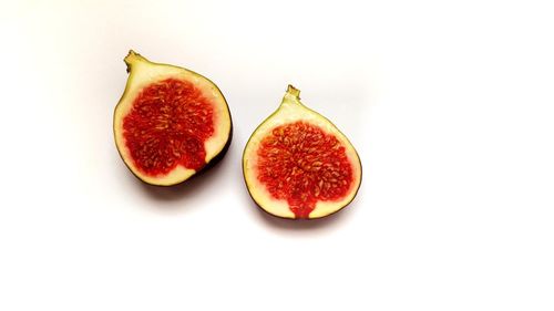 Close-up of red fruit over white background