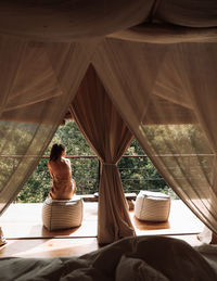 Rear view of women sitting in corridor