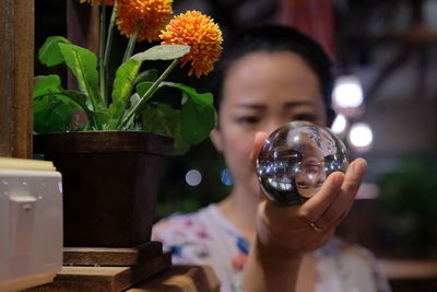Close-up of woman holding crystal ball