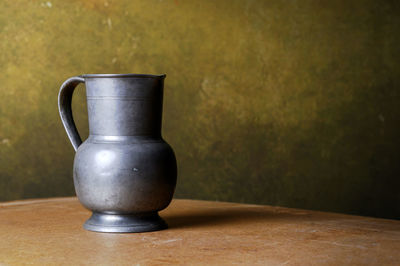 Close-up of drink on table against wall