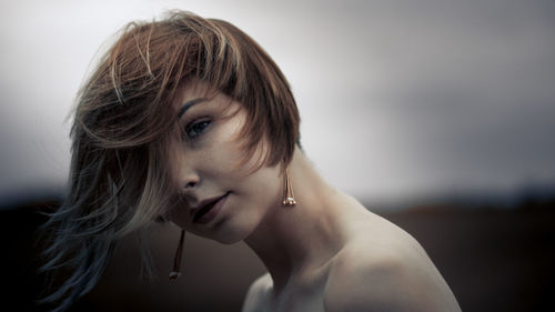 Close-up portrait of shirtless young woman