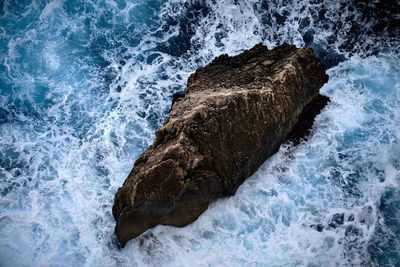 Sea waves splashing on rock