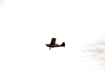 Low angle view of airplane flying against clear sky