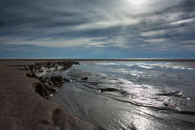 Scenic view of beach against sky during sunset