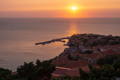 High angle view of sea against orange sky