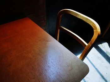 High angle view of empty chair on table at home