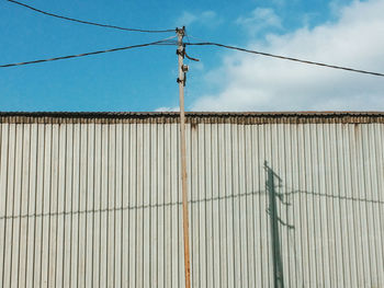 Low angle view of corrugated iron against sky