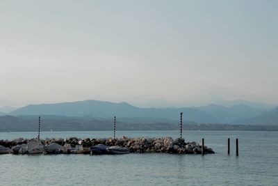 Motor boats in sea against sky