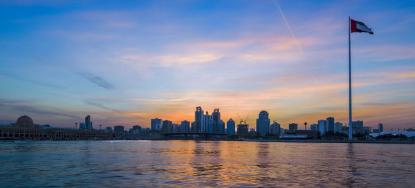 City at waterfront during sunset