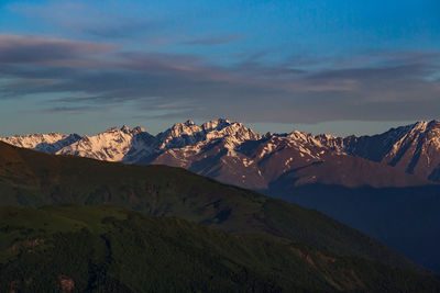 The mountains. scenic view of snowcapped mountains against sky during sunset