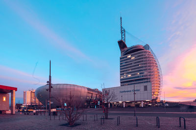 Buildings in city against sky during sunset