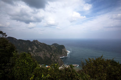 High angle view of calm sea against cloudy sky