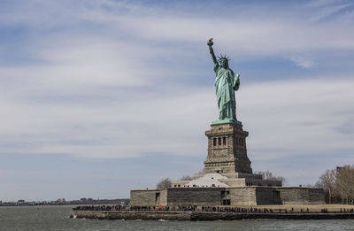 Statue of liberty against cloudy sky