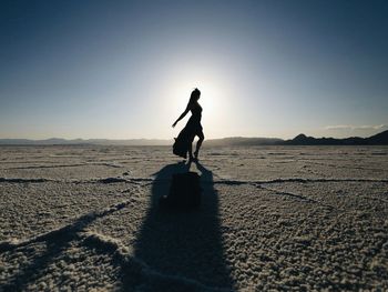 Full length of woman standing against clear sky