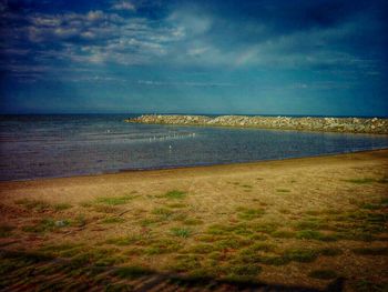 Scenic view of sea against cloudy sky