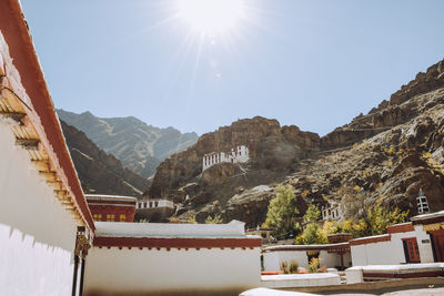 Scenic view of mountains and buildings against sky