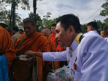 Group of people in traditional clothing against sky