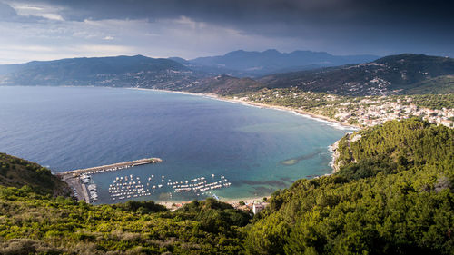 High angle view of sea and cityscape against sky