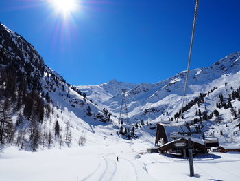 Scenic view of snow covered mountains against clear sky