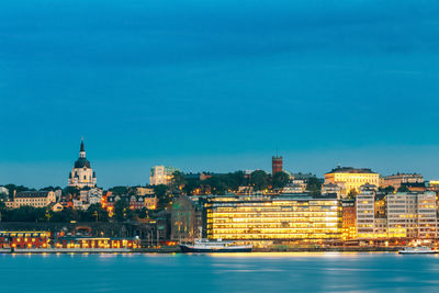 Buildings and harbor against blue sky