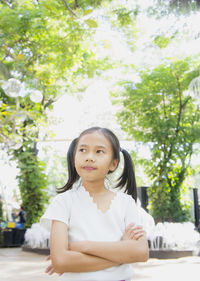 Cute girl looking away while standing at park