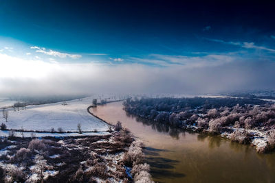 Aerial view of landscape against sky during winter