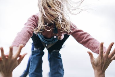 Man balancing girl while playing outdoors