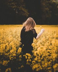 Young woman with flowers in field