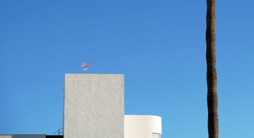 Low angle view of building against clear blue sky during sunny day