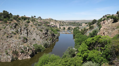 Panoramic view of trees and buildings against sky