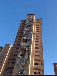 Low angle view of statue against blue sky