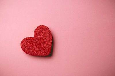 Close-up of heart shape against red background