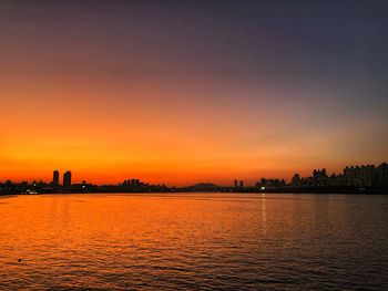 Scenic view of silhouette buildings against sky during sunset