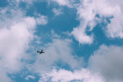 Low angle view of airplane flying in sky