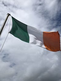 Low angle view of flag against cloudy sky