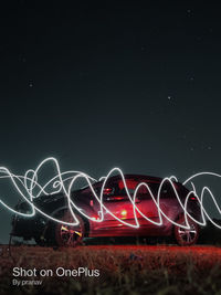 Illuminated light painting against sky at night