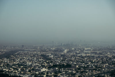 High angle view of city buildings against clear sky