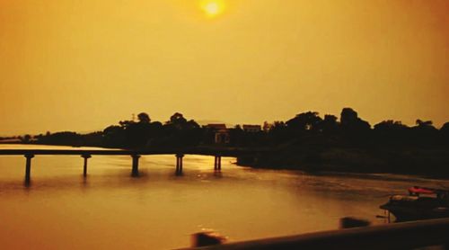 Scenic view of river at sunset