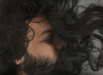 Close-up of young man amidst black hair