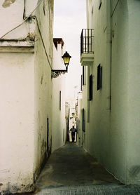 Aisle amidst buildings in city