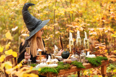 Side view of woman holding food outdoors