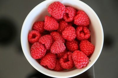 High angle view of raspberries in bowl on table