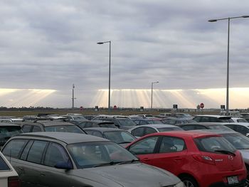 Cars in parking lot against sky