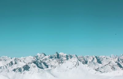 Scenic view of snow covered mountains against sky