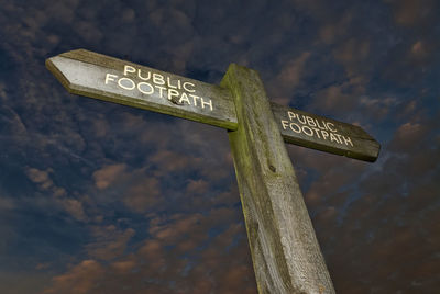 Low angle view of road sign at night