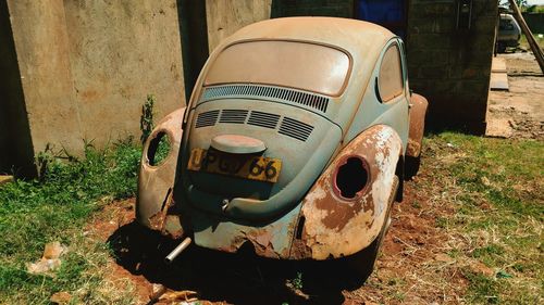 Close-up of abandoned car on field