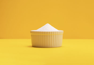 Close-up of dentures on yellow background
