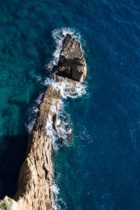 High angle view of rock formation in sea